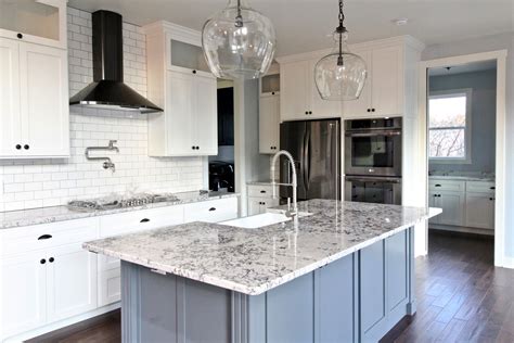 Variables like tile and appliances may change in the future, but your cabinetry tends to stick around a bit longer, so pick. Kitchen, Grey island, white cabinets, black stainless ...