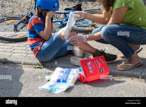 Symbolic Photo First Aid Scene Posed Wound Care After A Bike