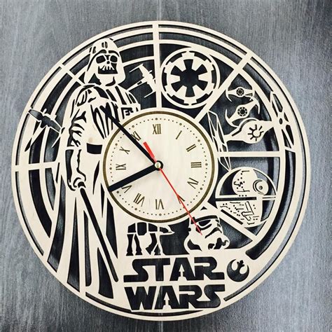 A Star Wars Themed Clock Is Shown On A Wooden Surface With Black And