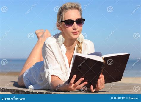 woman reads a book on the beach stock image image of learning lady 208807479