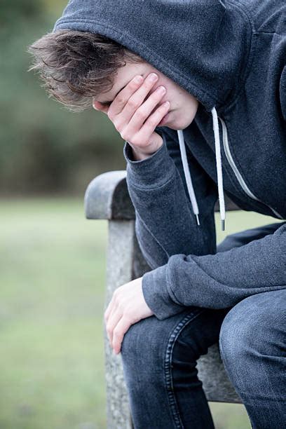 Sad Teenager Boy Crying Outdoors In Park Stock Photos Pictures