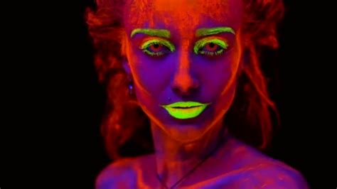 A Beautiful Young Sexy Half Naked Girl Dancing With Glowing Paint On