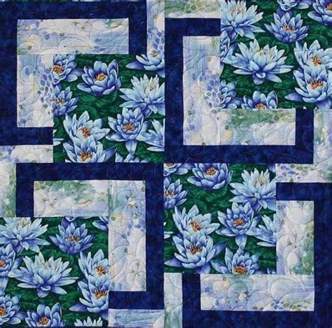 A Blue And White Quilt With Flowers On The Front Along With Squares In The Middle