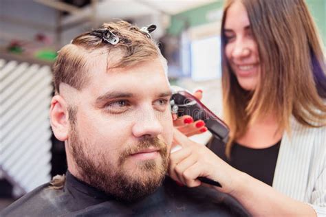 Hairdresser Woman Cutting A Man S Hair In A Barbershop Stock Image