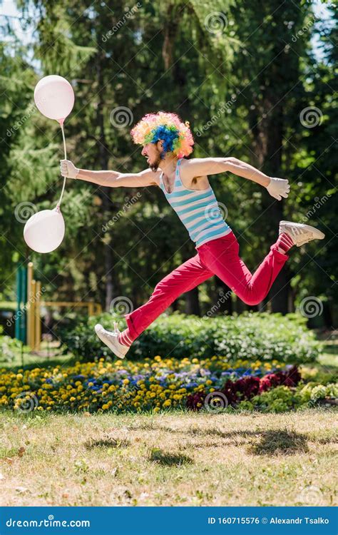 Mime Jumps In The Park With Balloons Clown In The Air Shows Pantomime