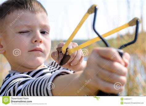 Young Boy Aiming Sling Shot At Camera Stock Image Image Of Preteen