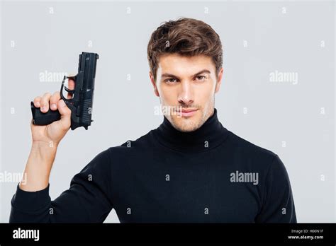 Portrait Of Handsome Young Man Holding A Gun Stock Photo Alamy