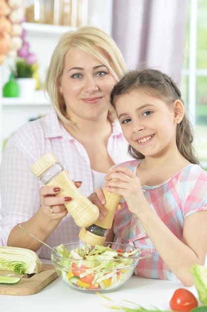 Premium Photo Mother And Daughter Cooking Together