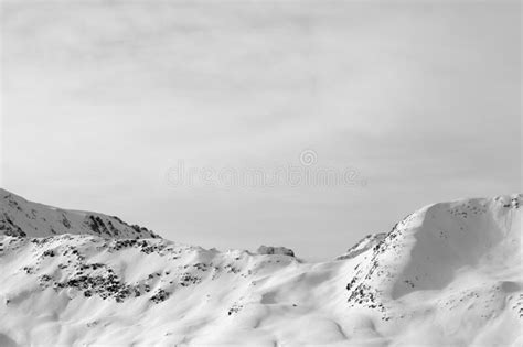 High Winter Mountains With Snowy Slopes And Sunlit Cloudy Sky Stock