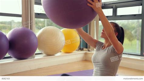 Sporty Brunette Woman Lifting Exercise Ball Stock Video Footage