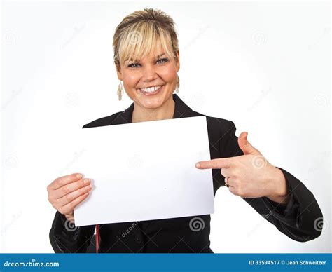 Studio Portrait Of A Cute Blond Girl Holding A Piece Of Paper Stock