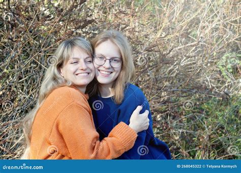 Happy Middle Aged Woman Enjoying Love Of Her Teenage Daughter On Mother`s Day Portrait Of