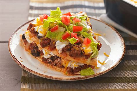 This vegetarian enchilada casserole is layered with black beans, green chiles, corn and lots of cheese. layered taco casserole flour tortillas