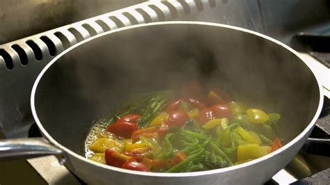 Close Up Chef Cooking Vegetables In Pan Mixed Vegetables Being Stewed