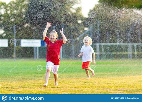 Kids Play With Water Child With Garden Sprinkler Stock