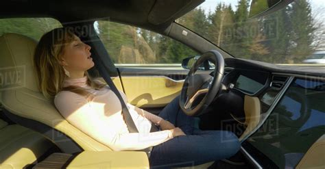 Close Up Tired Female Tourist Sleeps While The Technologically Advanced Autonomous Car Drives