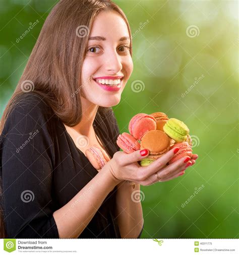 Young And Smiling Woman Holding A Bunch Of Colorful Macaroons On Stock Image Image Of Hair