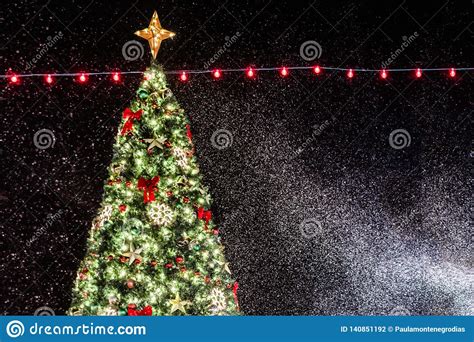 Christmas Tree Background With Beautiful Lights And Snow