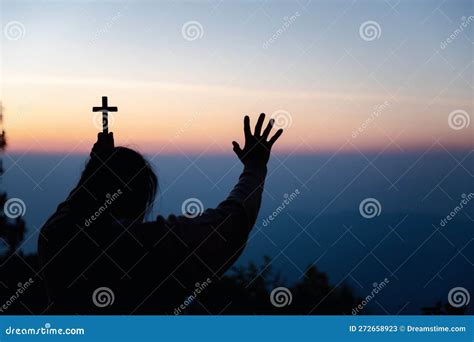 Silhouette Of Woman Kneeling Down Praying For Worship God At Sky
