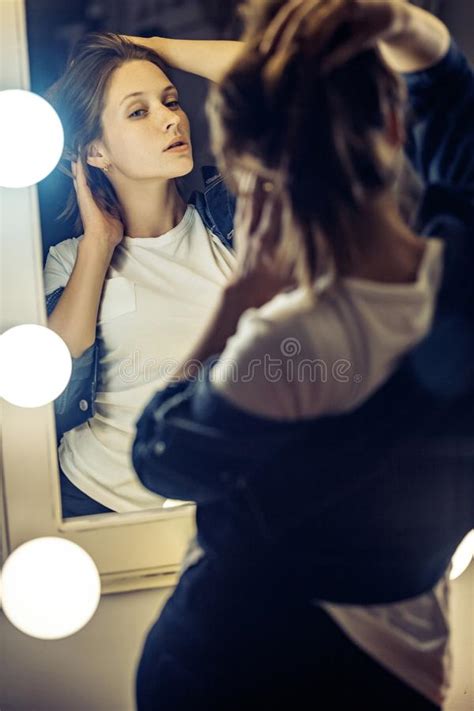 Portrait Of Woman Looking At Mirror Beautiful Girl Stands Stock Image