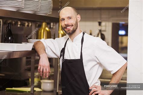 Happy Chef Standing At Commercial Kitchen — Portrait Focus On