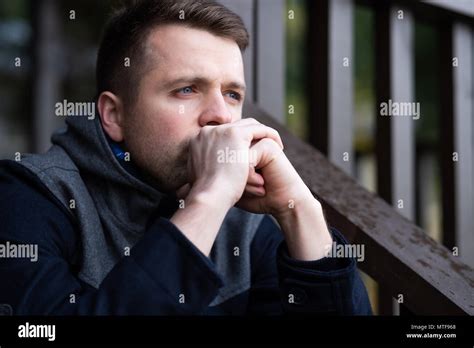 Sad Caucasian Man Sitting Alone And Thinling About Problems Stock Photo