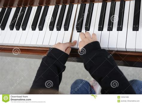 Little Girl Having Fun Playing The Piano Stock Photo
