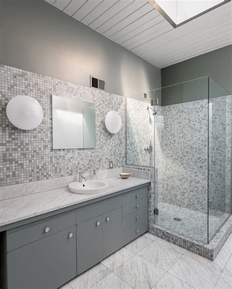 The rustic tiles from mosaic house that lines the shower are accessorized with fittings from waterworks and a why settle for one tile idea when you can enjoy two? Photo 13 of 19 in A Picture-Perfect Midcentury in Pasadena ...