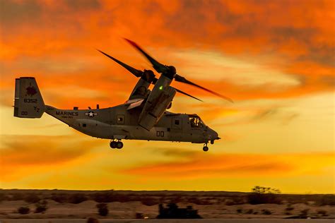 A Marine Corps Mv 22 Osprey Tiltrotor Aircraft Hovers Over The Desert
