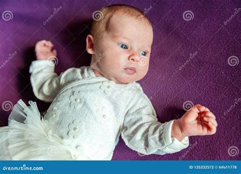 Soft Portrait Of Peaceful Sweet Newborn Infant Baby Lying On Bed While