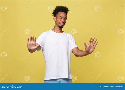 Portrait Of Furious Young Man Long Curly Hair Style Keeps Fists