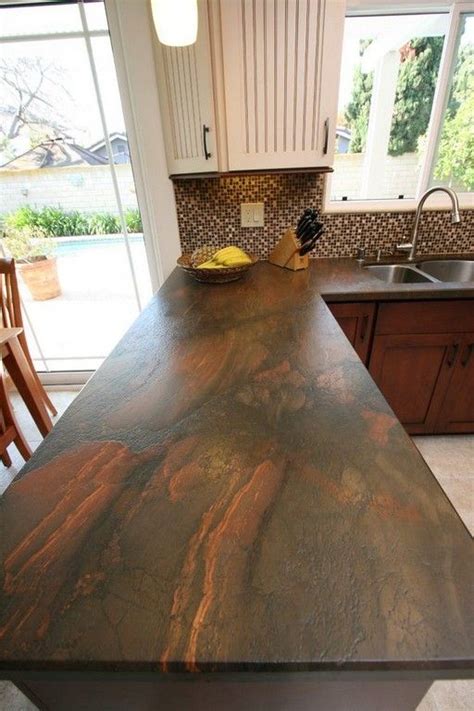 A Kitchen Counter Top That Is Made Out Of Wood And Has An Island In The