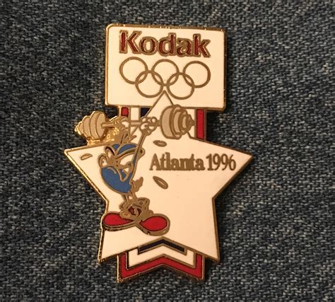 Mascot Izzy 1996 Olympic Lapel Pin Weightlifting Sponsor Kodak