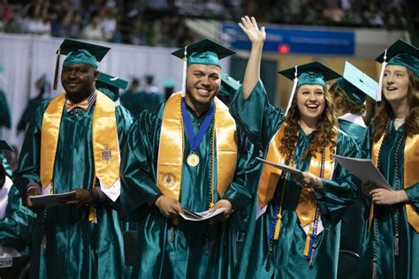 A Group Of Graduates Celebrate As They Wear They Phi Theta Kappa Stoles