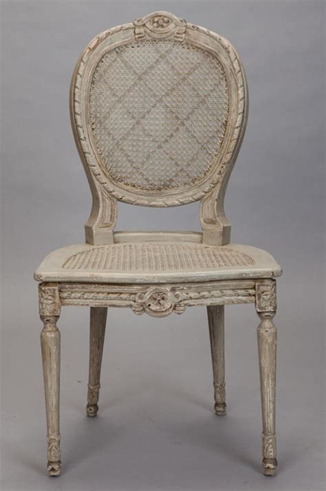 Featuring a curved back, tapered wood legs, and classic spindles, this dining chair is anchored by. Six French Painted and Caned Oval Back Chairs at 1stdibs
