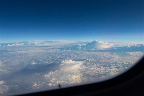 Blue Sky In The Porthole White Fluffy Clouds Below Blue Horizon View