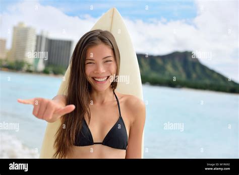 Surfer Girl Surfing Showing Mahalo Shaka Hand Sign Signal Saying Hello On Waikiki Beach Oahu