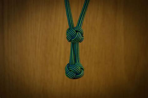 A Green Rope Is Hanging On A Wooden Wall