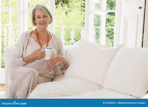 Woman In Living Room With Coffee Smiling Stock Image Image Of Looking