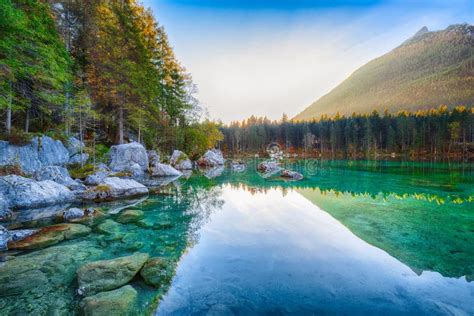 Beautiful Autumn Sunrise Scene With Trees Near Turquoise Water O Stock