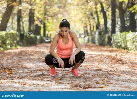 attractive sport woman in runner sportswear breathing gasping and taking a break tired and