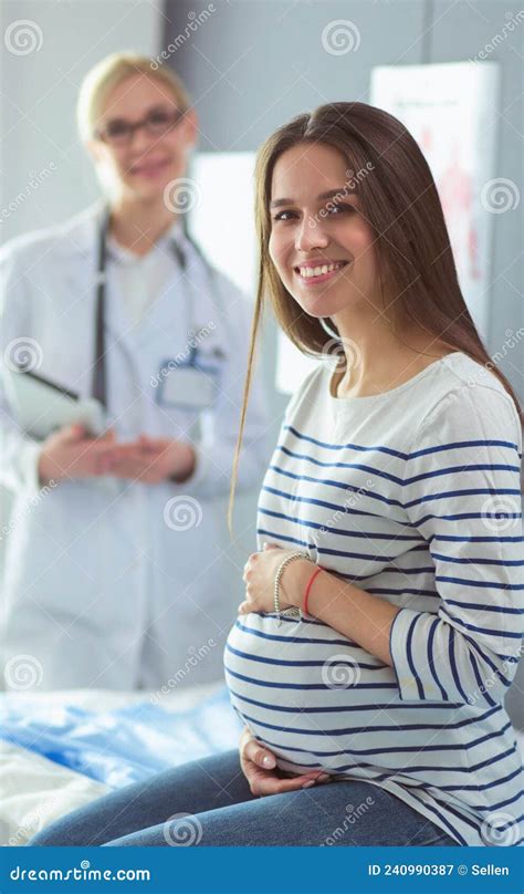 Beautiful Smiling Pregnant Woman With The Doctor At Hospital Stock