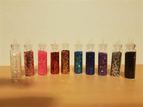There Are Many Different Colored Sand In Small Containers