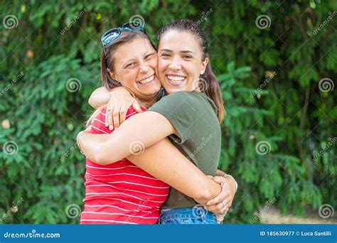 Portrait Of Two Young Beautiful Lesbian Smiling Girls Hug Each Other In A Summer Day Whit