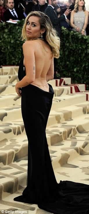 Miley Cyrus Turns Heads At Met Gala With Bold Backless Ensemble And Bra Free Statement Xt