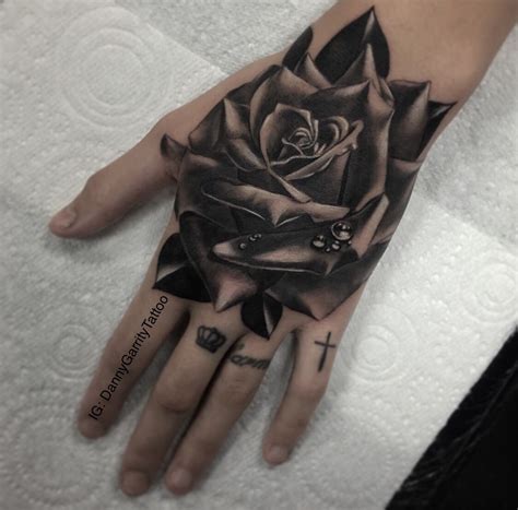 Realistic Rose Hand Piece Tattoo In Black And Grey On A Girl Hand