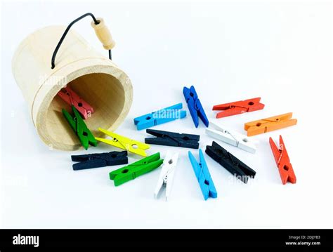 Multi Colored Clothespins And Bucket Over White Background Stock Photo