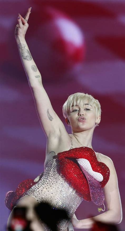 Miley Cyrus Shows Off Her Massive Tongue In A Bizarre Outfit