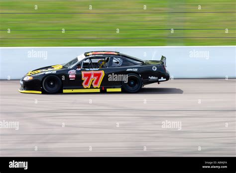 V8 Nascar Type Stock Cars Racing On A Banked Oval Circuit Stock Photo