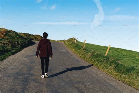 Young Woman Walking On Lonely Road Stock Photo Containing Adventure And